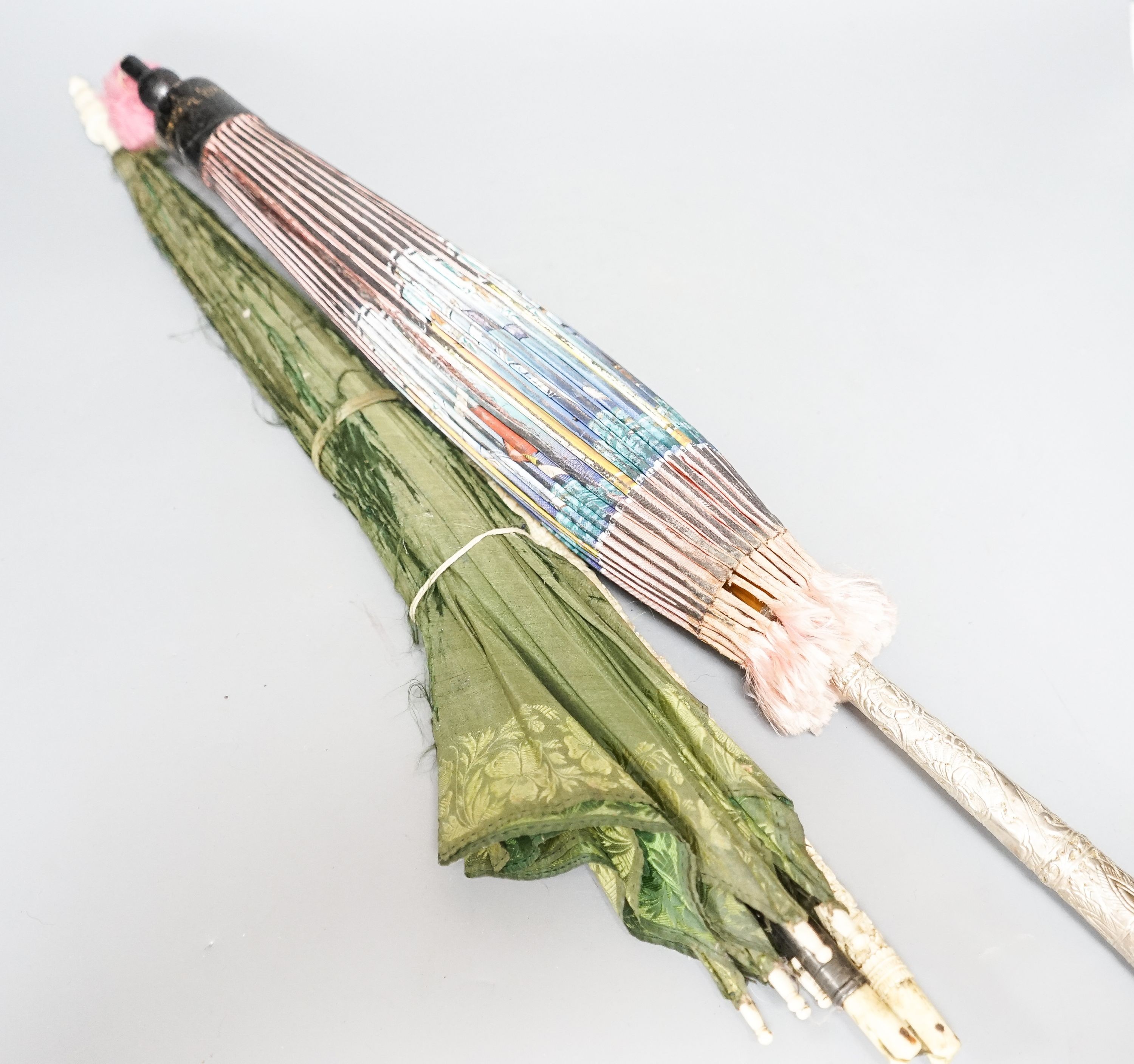 A 19th century Chinese Canton export ivory parasol with carved Ivory handle and a Burmese white metal handled painted fabric parasol